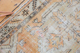 Vintage Oushak rug's visible texture with muted tangerine orange and seafoam geometric patterns.