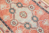 Distressed Oushak runner detail: worn floral and vine patterns in coral, silver, black.