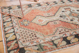 Detail of distressed hand-knotted Oushak rug, showing cinnabar, ivory stepped geometric motifs.