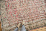 Distressed vintage Oushak rug underfoot, showing faded floral cross-sections and even wear.