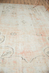 Distressed vintage Oushak carpet texture with tone-on-tone pale blush and faded motifs.