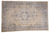 Distressed Vintage Oushak rug, ivory field, faded royal blue scalloped medallion, floral elements, 7' x 10'5
