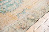 Textured vintage Oushak rug with decorative wear, faded apricot field, and aqua border.