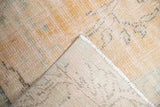 Vintage Oushak rug corner showing distressed peach apricot pile and hand-knotted ivory reverse.