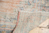 Distressed Oushak rug close-up, showing worn pile, visible foundation, and reverse.