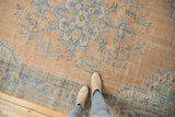 Distressed vintage Oushak carpet texture with pale peach, faded blue, mint floral motifs, even wear.
