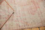 Distressed hand-knotted Oushak rug texture in muted blush rose and cotton white.
