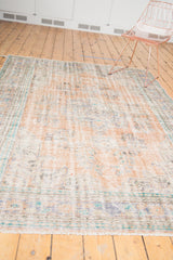 Distressed Oushak rug pile with visible knot heads and secured fringe.
