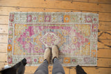 Distressed Oushak rug with an oblong medallion, stepped spandrels, and soft patina colors.