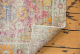 Distressed vintage Oushak rug corner revealing hand-knotted foundation and intact selvage.