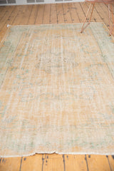 Secured fringe and distressed apricot, ivory, mint pile with foundation showing.