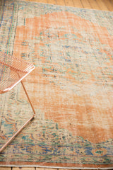 Distressed Oushak rug texture with soft blush, blue, and ivory tones.