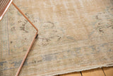 Distressed vintage Oushak carpet, worn pile and faded sand, denim blue, and mint.