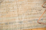 Distressed vintage Oushak rug detail: mostly even wear, pale sand, ivory, faded blue tones.