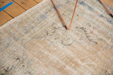 Distressed Oushak rug with faded sand, blue, and mint green tones, showing even wear.