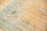 Distressed Oushak carpet detail: apricot, faded mint, blue Rococo patterns, foundation wear.