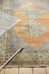 Distressed vintage Oushak rug in terracotta, faded royal blue, and antique ivory abrash.