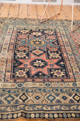 Hand-knotted antique Shirvan rug's intricate geometric lower border and natural fringe.
