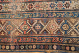 Antique Shirvan rug detail with nuanced geometric patterns in time-softened blush and blue.