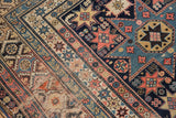 Antique Shirvan rug with intricate geometric motifs and diverse banded borders in blues and blush.