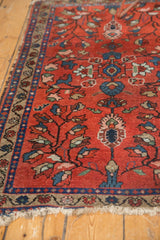 Finely woven border detail of vintage Lilihan rug, showing low pile and tattered fringe.