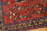 Finely woven low pile of vintage Lilihan rug in cherry red with ornate floral motifs.