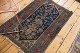 Kurdish Hamadan rug, upper corner showing stepped terracotta and navy spandrels, worn side.