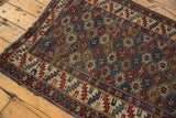 Antique Shirvan rug detail: mallard green, wine red gul motifs. Ivory geometric serrated leaf border.