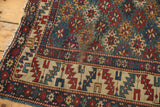 Tattered corner of antique Shirvan rug with geometric serrated leaf border and mallard green gul motifs.