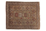 Antique Caucasian square rug: bronze field, wine-red guls, center medallion, stylized border figures.
