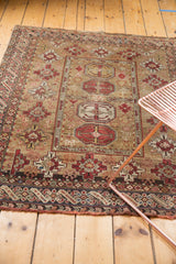 Antique Caucasian square rug with geometric guls, intricate borders, pale bronze and rust red.