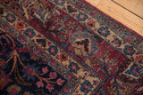 Worn wine red field, delicate tendrils, and floral patterns on this vintage Meshed rug.