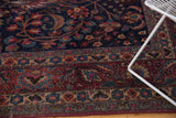 Vintage Meshed carpet, navy field, detailed wine red and sky blue floral pattern.