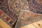 Antique hand-knotted Persian Senneh rug reverse with adhered pad and tattered fringe.