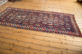 Worn lower corner of the antique Caucasian runner, with geometric border and fragmented botehs.