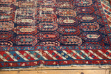 Antique Caucasian rug: detail of red, blue, beige striped border and worn navy boteh field.