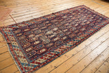 Top right detail of antique Caucasian runner with colorful staggered botehs and striped border.