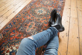 Vintage Heriz runner, alternating contour geometric patterns in dusty brick red, navy, and mallard green.