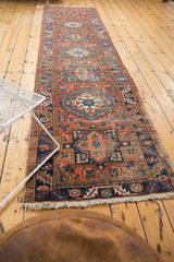 Heriz runner end, hand-knotted, geometric and curvilinear patterns, dusty brick red, and fringe.