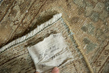 Hand-knotted foundation, fringed edge, and cleaning tag on a vintage Tabriz rug.
