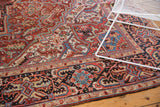 Geometric vinery and elaborate border pattern in madder root red and charcoal blue.