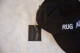 Branded Rug Addict hang tag attached to the black embroidered baseball cap.