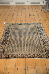 Antique Farahan Sarouk rug showing vertical wave design, intricate border, and light end loss.