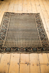 Bottom edge of the antique Farahan Sarouk rug showcasing intricate border pattern and original, aged fringe.