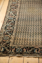 Intricate meandering wave design field and rare floral border on the antique Farahan Sarouk rug.