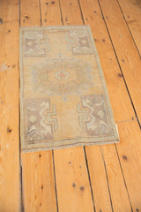 Distressed vintage hand-knotted Oushak rug corner, showing white knots, oxidized silver tones, fringe.