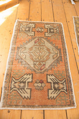 Distressed Oushak rug mat with faded apricot field, oxidized silver medallion, and soft worn texture.