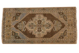 Vintage Distressed Oushak mat with quatrefoil medallion, bronze, faded blue, and ivory tones.