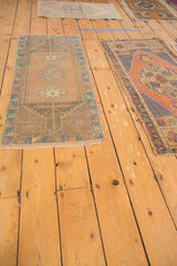 Distressed Oushak runner's end, with light loss, intact selvage, and geometric border.