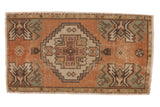 Distressed vintage Oushak rug, medallion, geometric forms, softened earth tones, 1'6
